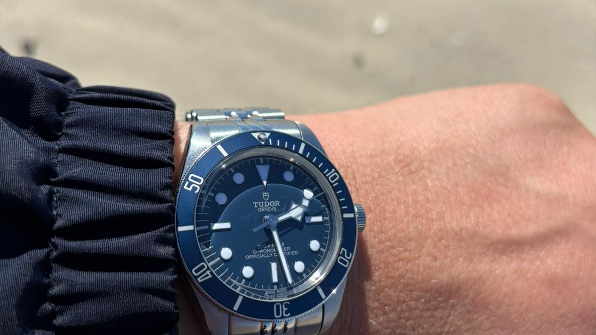 Tudor Black Bay Fifty-Eight Navy Blue dive watch worn on the wrist at the beach